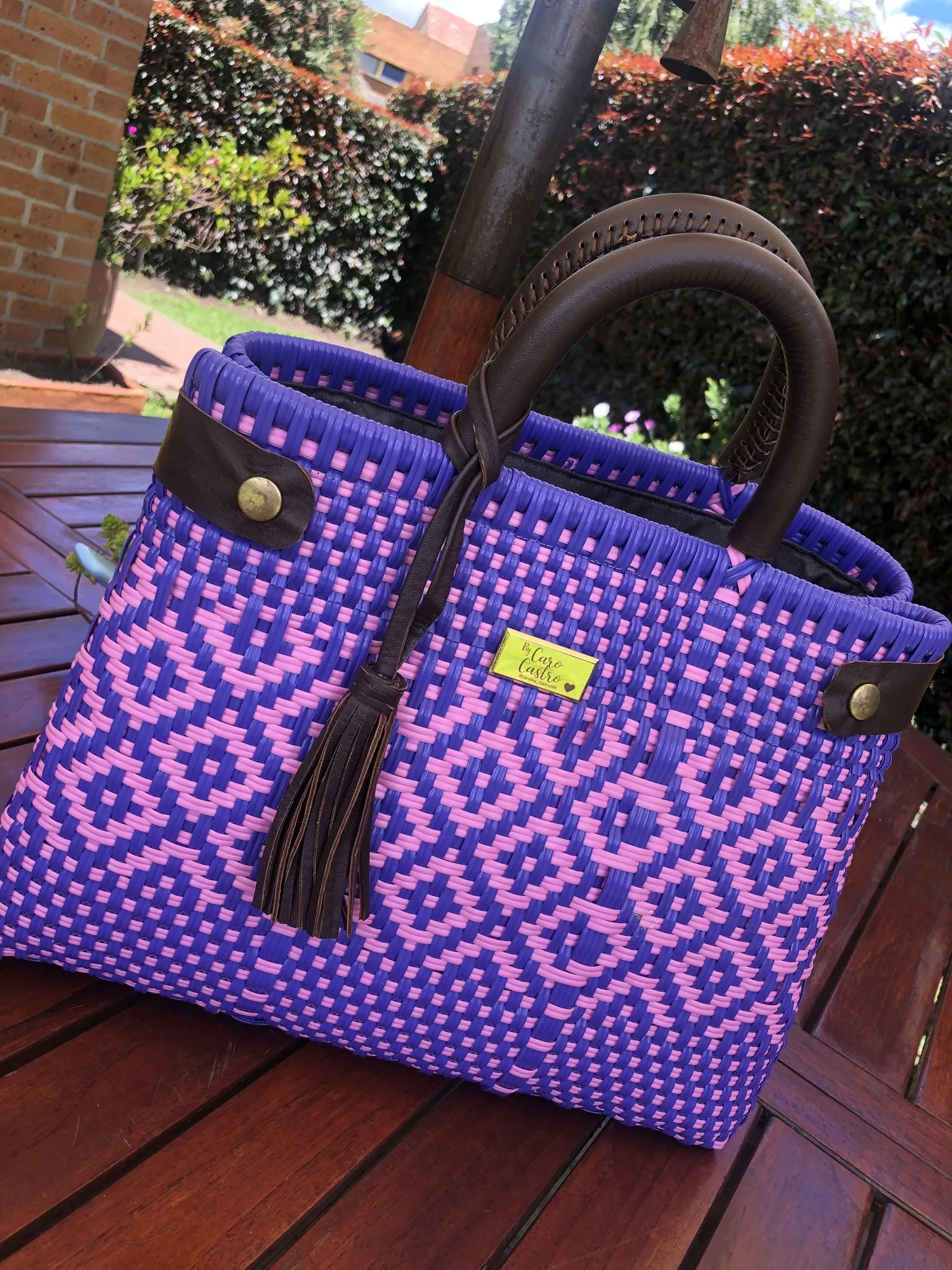 Cartera morada con rosado tejida a mano.